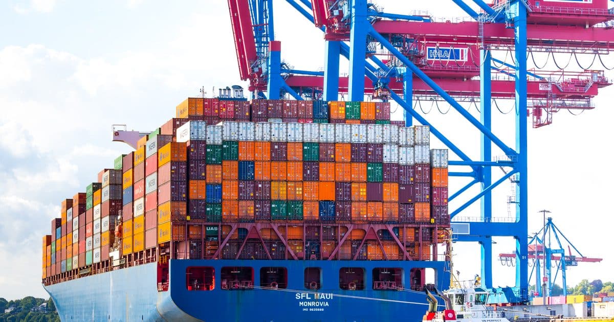 Container ship alongside under gantry cranes