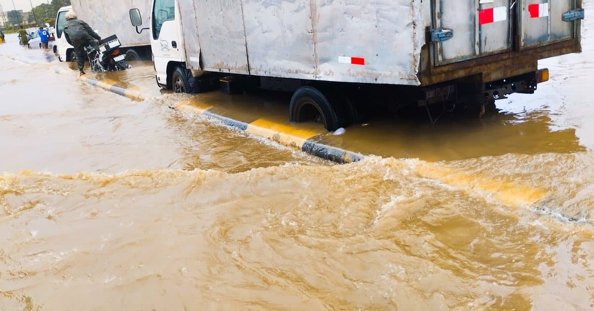 Truck in a flooded, rain eroded road in Lagos, Nigeria