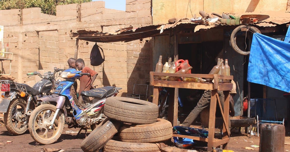 Fuel sold in bottles outside a motorcycle workshop in Bamako