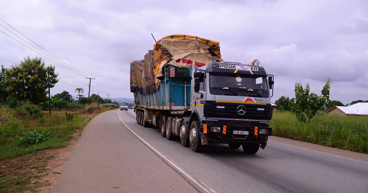 Semi trailer loaded far above its sides on a Ghanaian highway heading for Burkina Faso