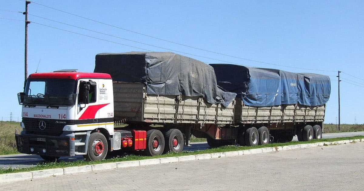 Tarpaulin covered truck loaded on a West African road